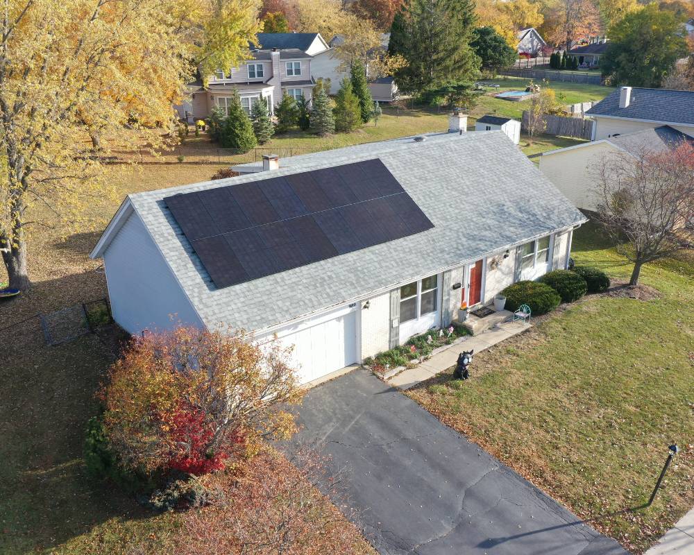 Aerial view of solar panels installed on the room of a hoffman estates home.